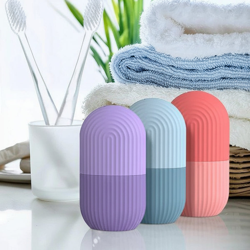 Three cylindrical containers in purple, blue, and pink with a cup and toothbrushes in the background.