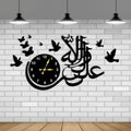 Decorative wall clock with Arabic calligraphy and birds on a white brick wall.