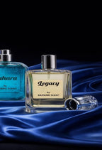Two perfume bottles, one blue and one clear with a silver cap, on a dark background.
