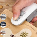 Hand using a white kitchen tool on a piece of paper with 'Jbi by Smart Deals' branding.