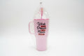 Pink mug with motivational quote in clear packaging on a blurred background