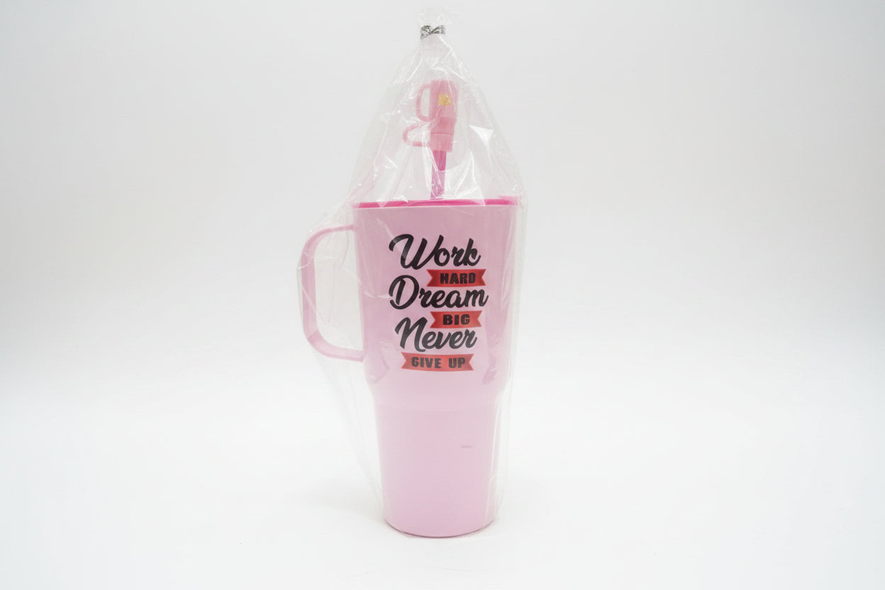 Pink mug with motivational quote in clear packaging on a blurred background