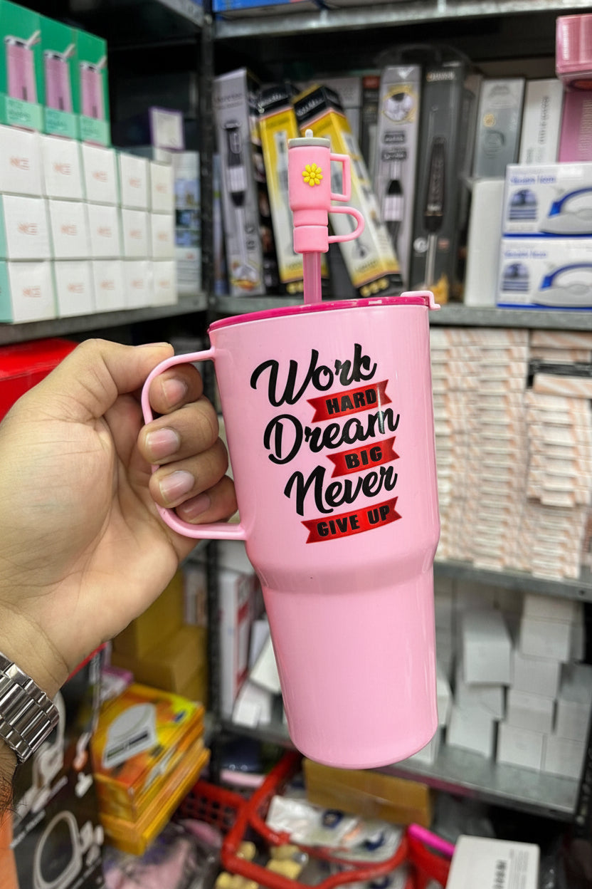 Pink mug with motivational quote held by a hand in a store setting, with 'Jbi' branding visible.