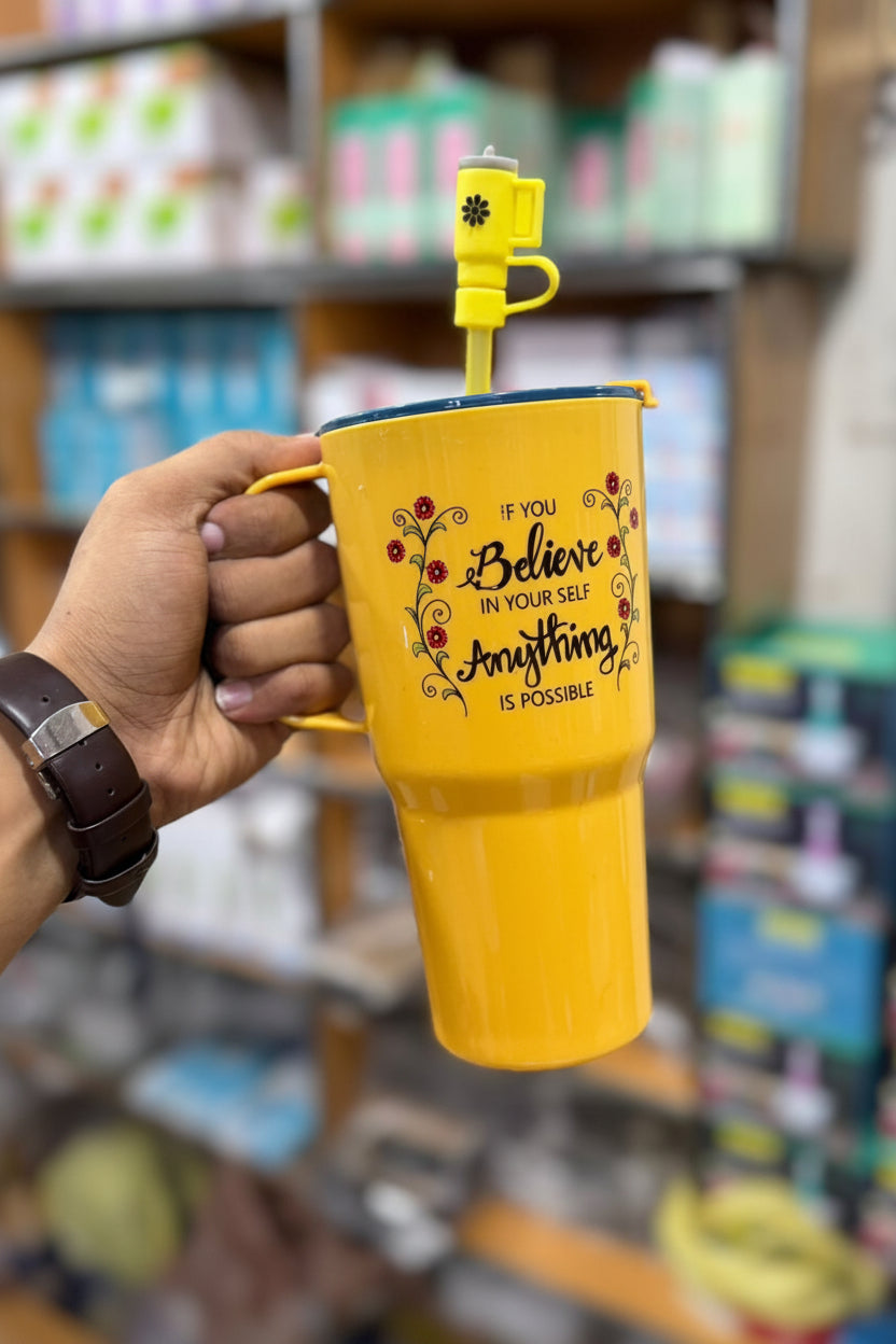 Yellow tumbler with motivational quote held by a hand in a store setting, featuring the brand 'Jbi by Smart Deals'.