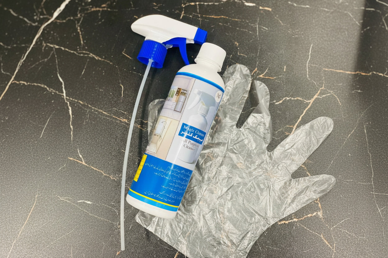 Cleaning spray bottle with blue and white label on a textured surface, featuring 'Jbi' branding.
