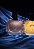 Two perfume bottles labeled 'Zaman' and 'Whisper' by Rafiero Scent on a blue fabric background.